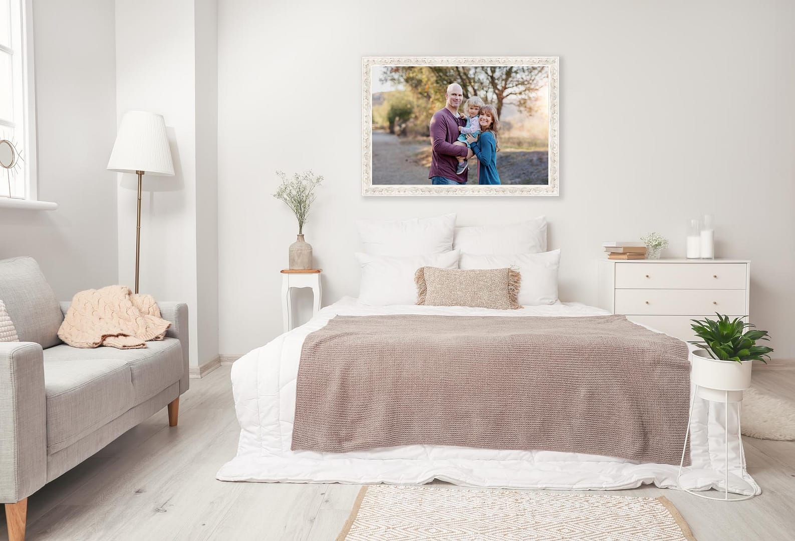 Stylish interior of modern bedroom depicting a large framed wall print of a family photography session by San Diego Professional Photography Studio