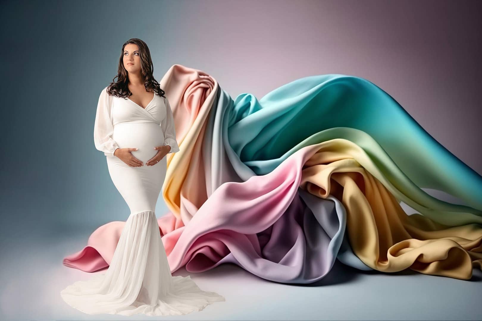 San Diego Pregnancy Photographer capturing mom to be in white maternity dress with a rainbow colors fabric flying behind