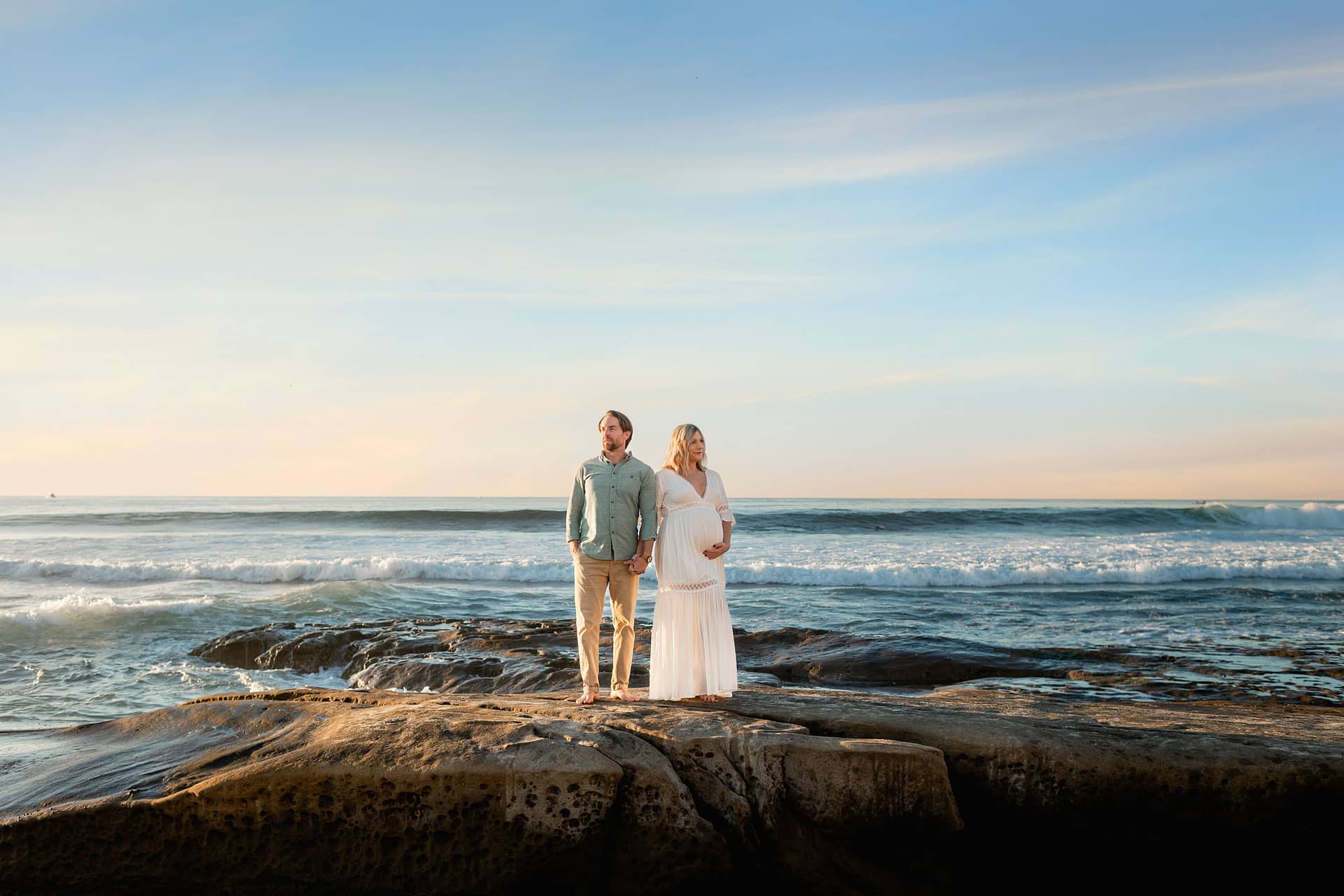 Couple posing outdoors on La Jolla Beach Cliffs during Maternity Photoshoot