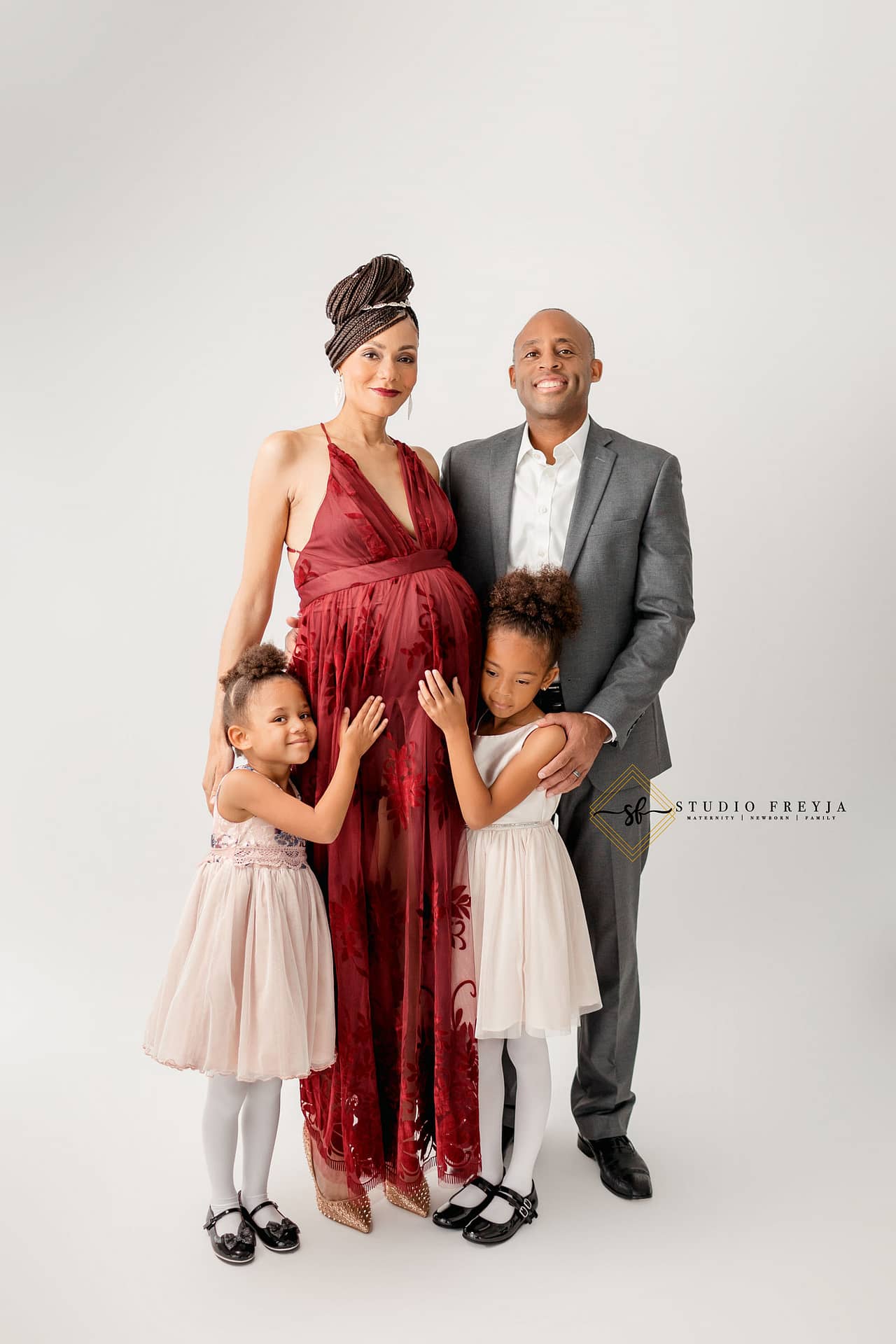 Proud family portrait in the studio during maternity session
